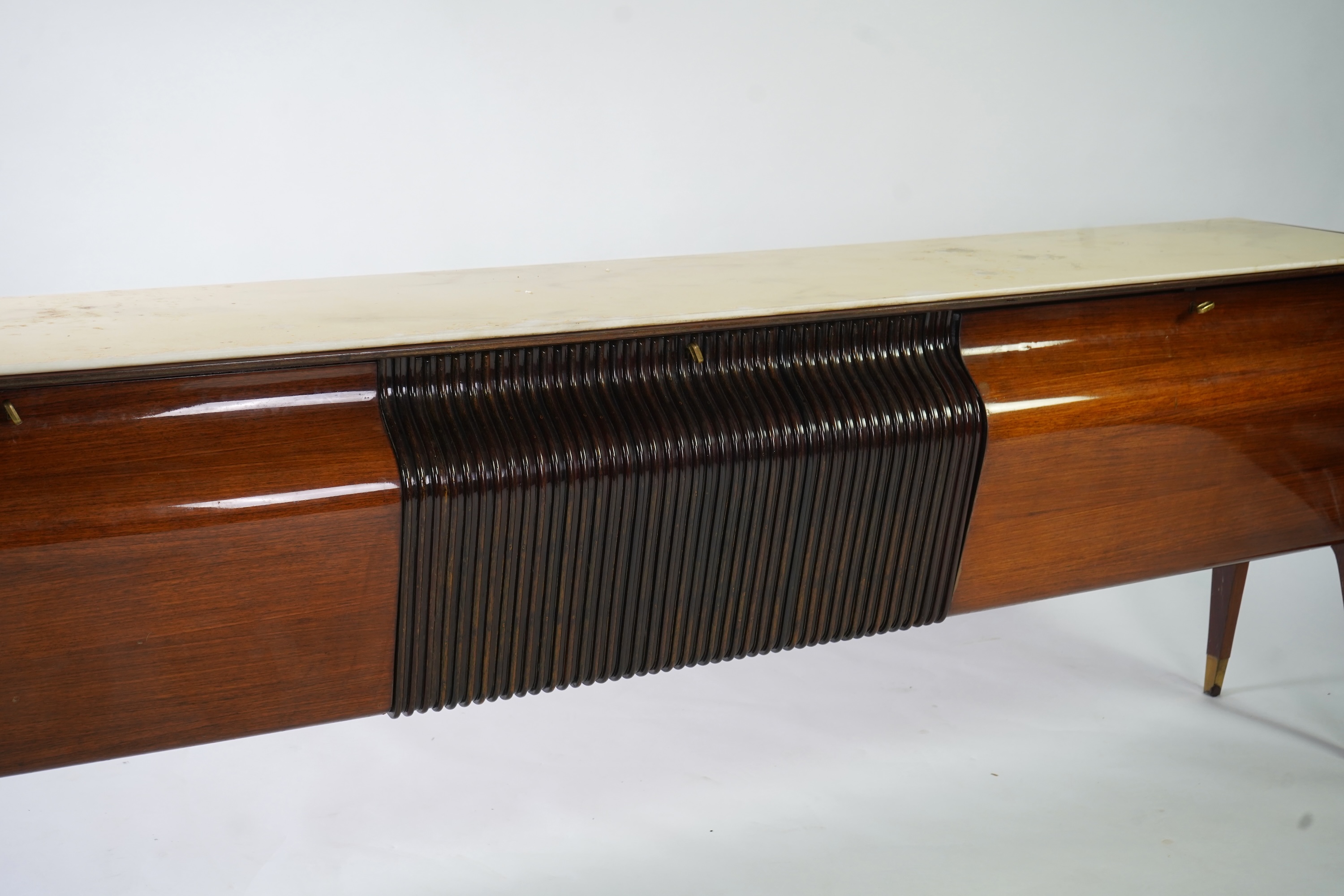Osvaldo Borsani (Italian, 1911-1985) for Atelier Borsani Varedo: A large Indian rosewood and mahogany credenza, 276.5cm wide x 49cm deep x 94cm high